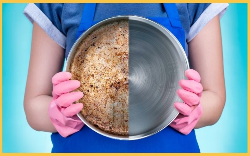 A person in pink gloves holds a split frying pan: one side is dirty and greasy, while the other side is shiny and clean.